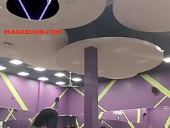 Masked woman exercises solo at the gym